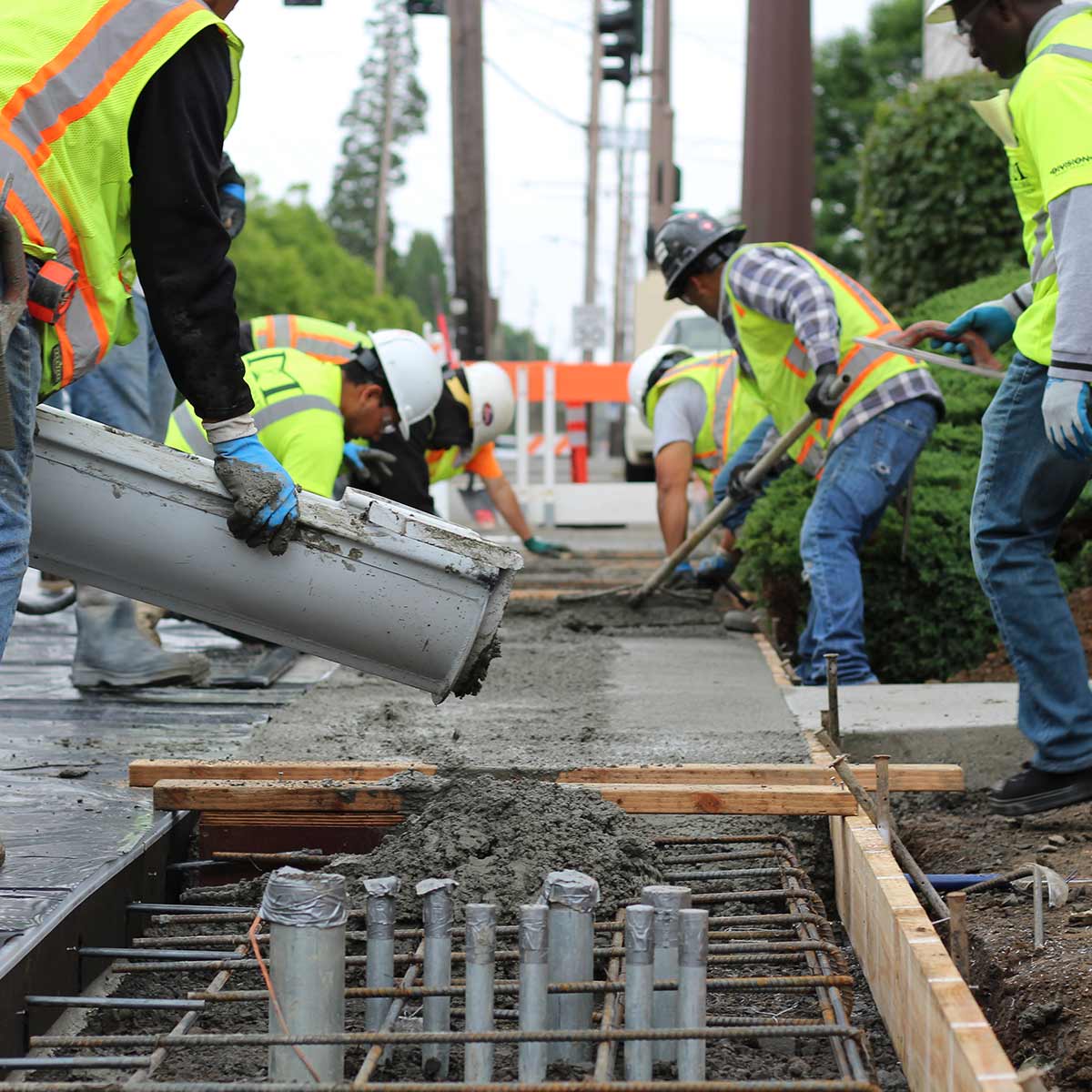 photo of a construction workers pouring concrete