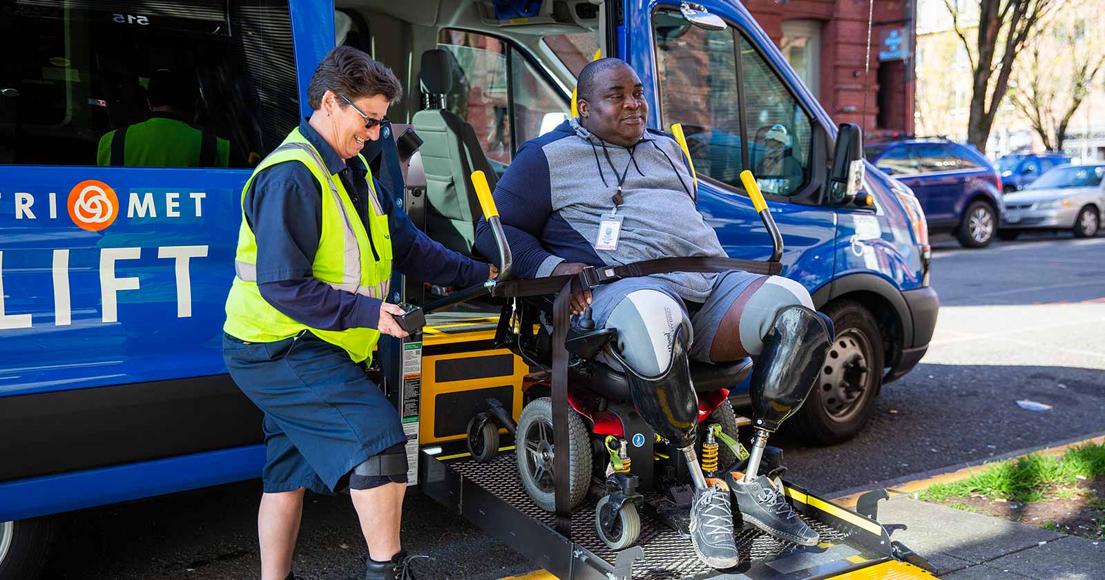 LIFT operator assisting rider with mobility device into TriMet vehicle via lift ramp
