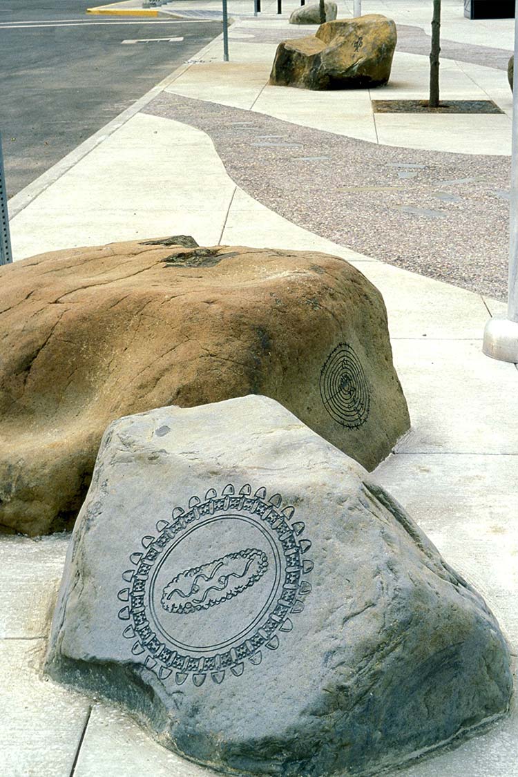 Paved path with embedded etched boulders