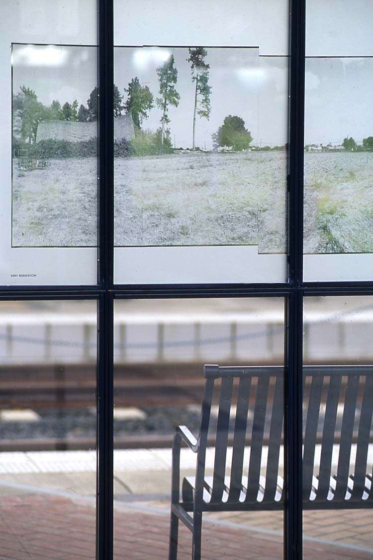 Time window sculpture with bench facing large photographic landscape installation