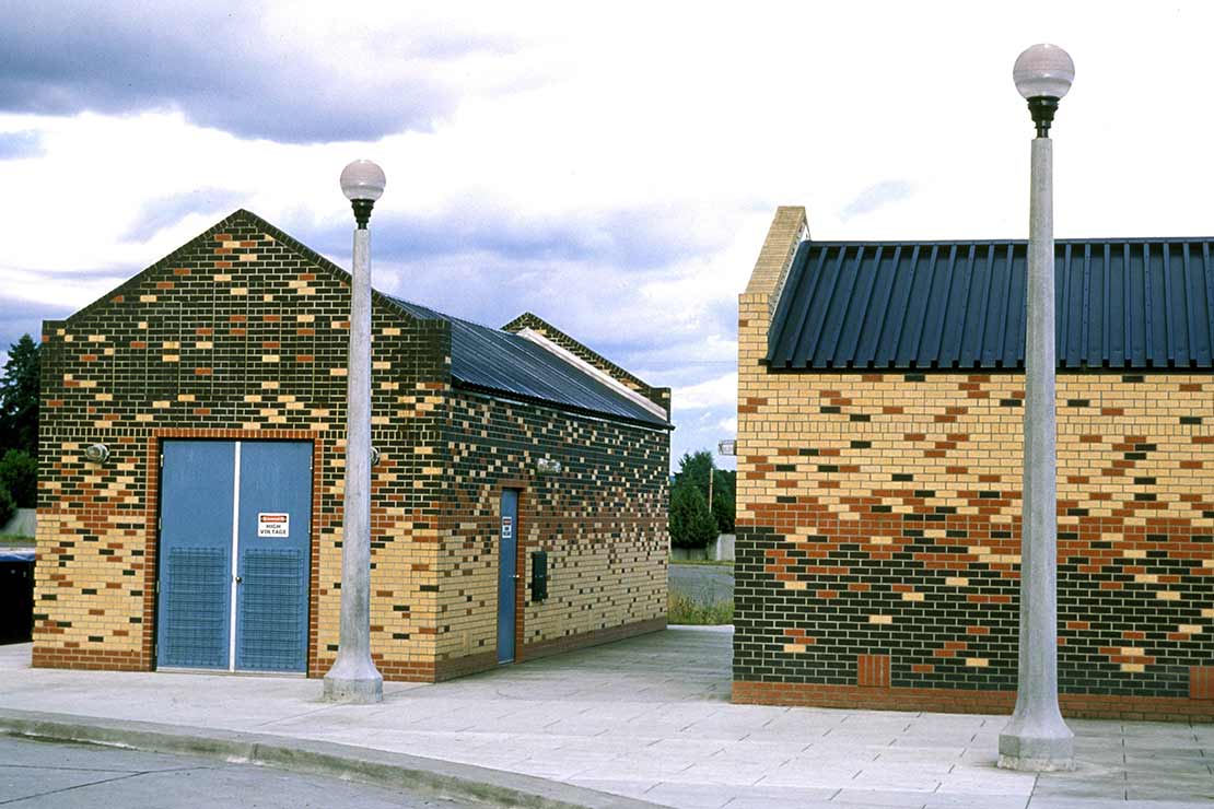 Systems buildings with multi-color red, green, and yellow brick facades