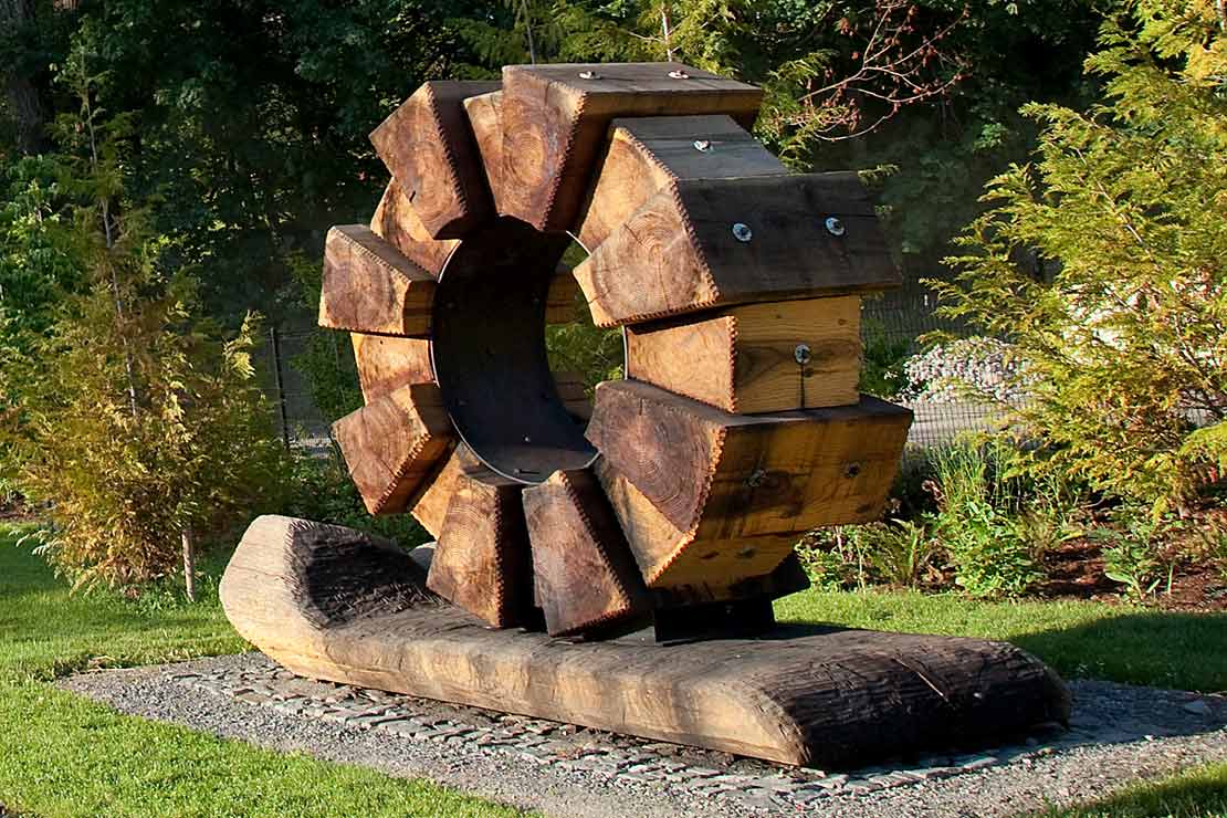 'Flow' - a wooden sculpture in the shape of a geared wheel