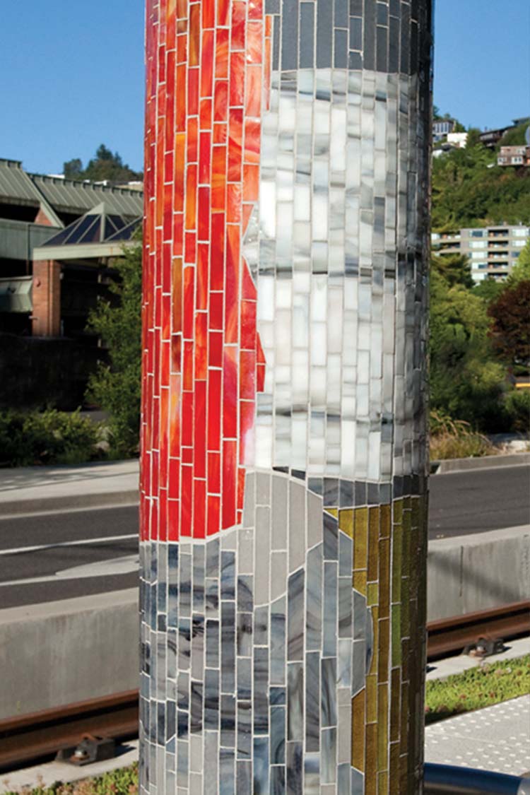 Mosaic tile on a bus shelter column titled 'Journey Through Time'