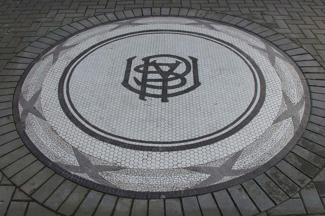 Medallion - mosaic tile embedded in concrete with Portland Union Stockyards symbol
